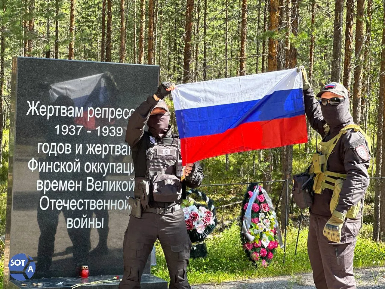 В урочище Сандармох прошла мемориальная встреча с участием родственников репрессированных, историков, активистов и дипломатов; мероприятие сопровождалось флагами и обсуждением прошлого.